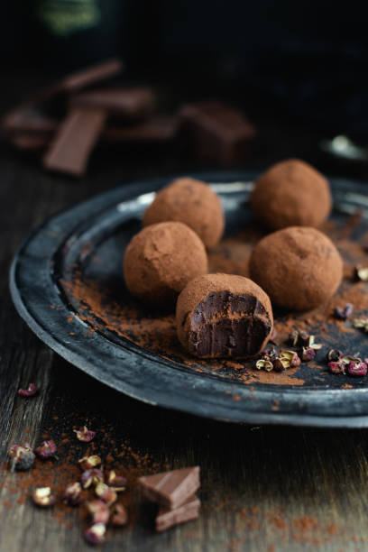 istock dark chocolate candy truffles with sichuan pepper on dark background 1163985135