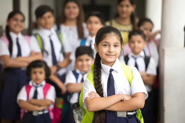 Photo of Group of schoolboys and schoolgirls at school campus