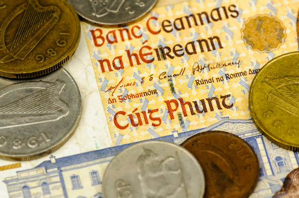 Irish punt bank note and coins Irish punt bank note and coins irish punt note stock pictures, royalty-free photos & images