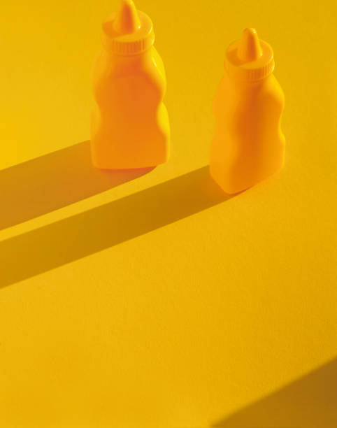 Mustard, Mayonnaise bottles with plastic corns and spoon. Culinary concept. Copyspace included.