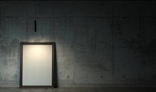 Dark room in the twilight with empty blank white poster in black frame standing on the floor. Gloomy interior in loft style with copy space. 3D rendering.