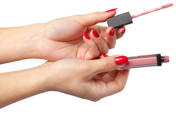 istock lipstick in hand isolated on white . 1163988701