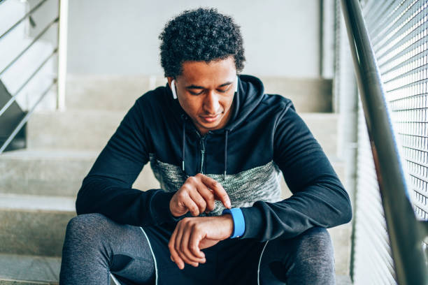 Athlete looking at his smart watch