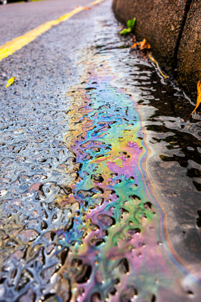 istock Spilt Petrol Gasoline Oil Running Down a Drain On a Road Gutter Environmental Pollution 1163991365