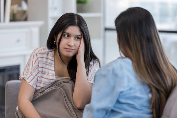 Mom helps teen overwhelmed by her problems When the teenage girl is overwhelmed by her problems, the mother tries to give her advice and encouragement. mom and sister stock pictures, royalty-free photos & images