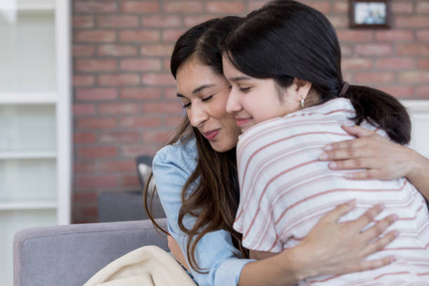 Mother and daughter hug affectionately