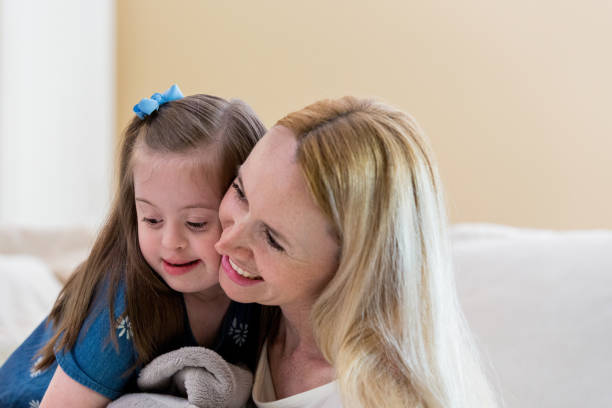 istock Mom snuggles with young daughter 1163992013