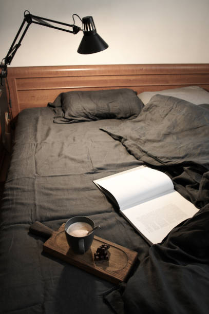 istock Coffee latte and chocolate in unmade bed 1163992231