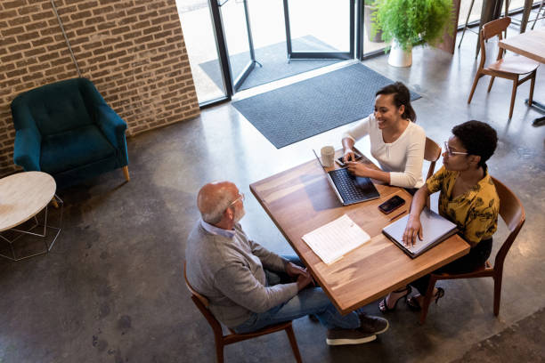 istock Confident business colleagues in coffee shop 1163992314