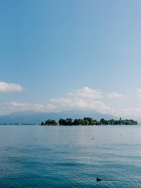 istock Blue lake Chiemsee against spectacular mountains and sky 1163992427