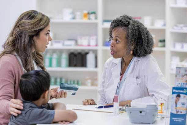 istock Pharmacist has serious conversation with customer's mom 1163992454