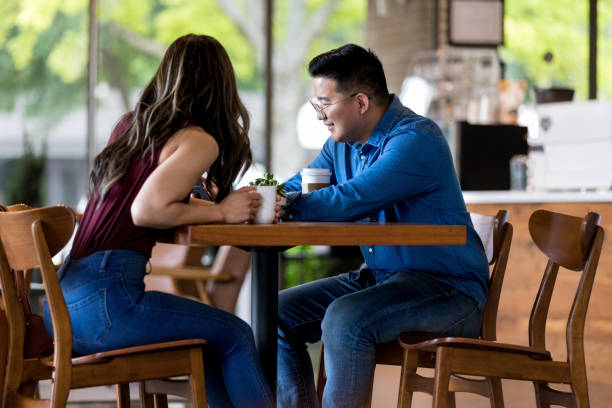 istock Couple looking at smartphone in cafe 1163992457