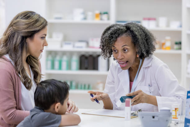 istock Pharmacist gives important instructions to young customer 1163992461