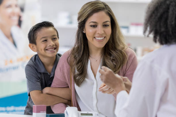 istock Female pharmacy receives medication from pharmacist 1163992501