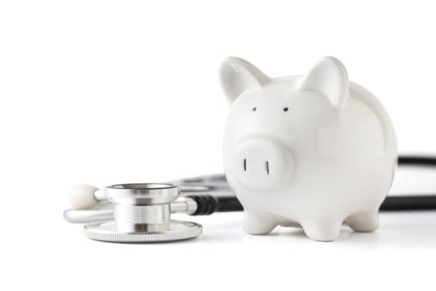 istock Piggy bank with stethoscope on white background 1163992857