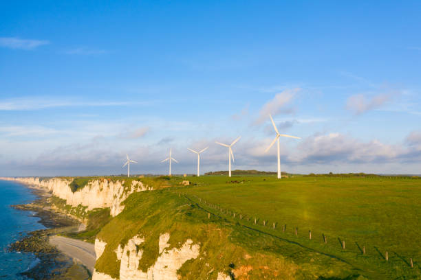 istock Five wind turbines in a Norman field by the sea 1163993863