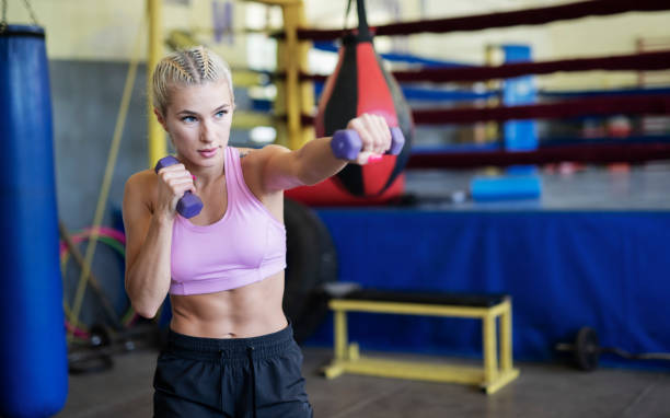istock Young woman boxing indoor. 1163995252