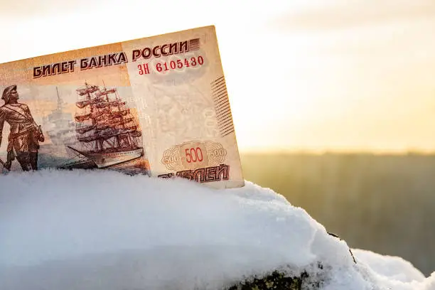 Russian banknote 500 rubles on the background of the sky and the snow in winter, the frozen money
