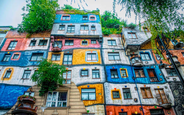 Colorful Hundertwasser House. Tourist attraction of Vienna Vienna, Austria - July 13, 2019: colorful bright house, designed by renowned Austrian architect Friedensreich Hundertwasser. The streets of ancient Vienna, the tourist attraction of Austria hundertwasser house stock pictures, royalty-free photos & images