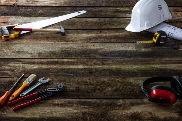 istock Safety hard hat, architect blue print and tools over wood 1164001705