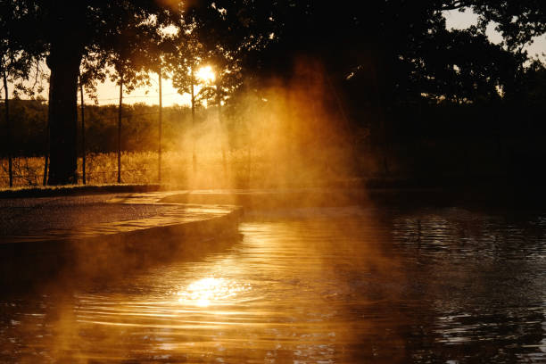 istock Sunrise with steam over pool. 1164002152