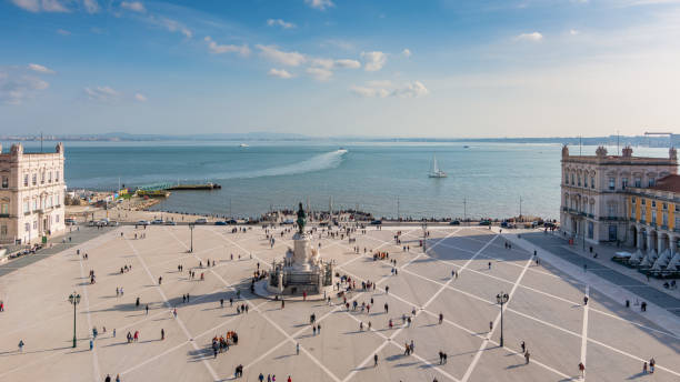 istock Panoramic view from the observation deck to the Commerce square in Lisbon, Portugal on a clear Sunny day, blue sky with clouds, sea view, on the water a beautiful trail from the ship 1164003274