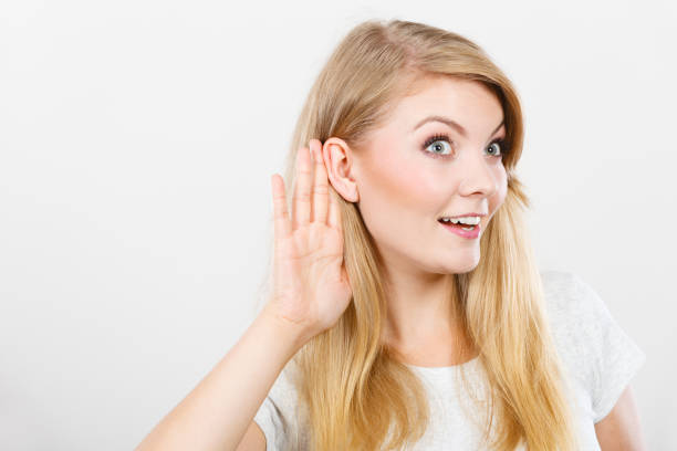 istock Woman putting hand ear to hear better 1164004007