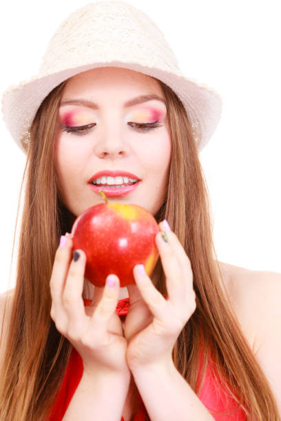 istock Woman summer hat colorful makeup holds apple fruit 1164006437