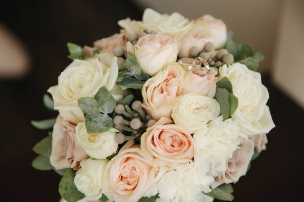 istock White gold rings on wedding bouquet. flowers 1164007435