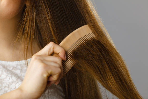 istock Happy woman brushing her hair 1164008503