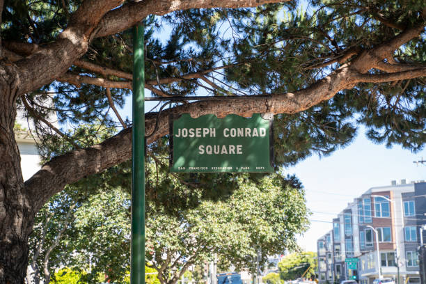 Sign for Joseph Conrad Square, a small city park located along Columbus Avenue near Fishermans Wharf San Francisco, California - July 10, 2019: Sign for Joseph Conrad Square, a small city park located along Columbus Avenue near Fishermans Wharf columbus avenue stock pictures, royalty-free photos & images