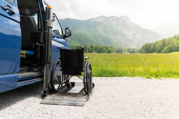 istock Black electric lift specialized vehicle for asistance for people with disabilities. Empty wheelchair on a ramp with nature and mountains in the back 1164009615