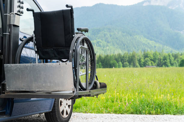 istock Black electric lift specialized vehicle for asistance for people with disabilities. Empty wheelchair on a ramp with nature and mountains in the back 1164009644