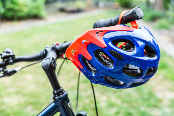 istock Bike helmet hangs from the handlebars of a bicycle 1164009656