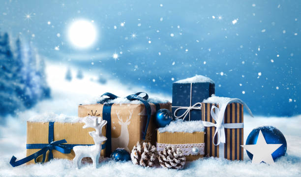 istock Christmas gift boxes in snow on winter snow landscape background 1164010884