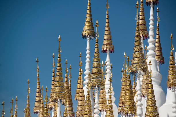 the white and golden Stupas and chedi at a rood of a temple at Wat Pong Sunan Temple in the city of  Phrae in the north of Thailand.  Thailand, Phrae November, 2018.