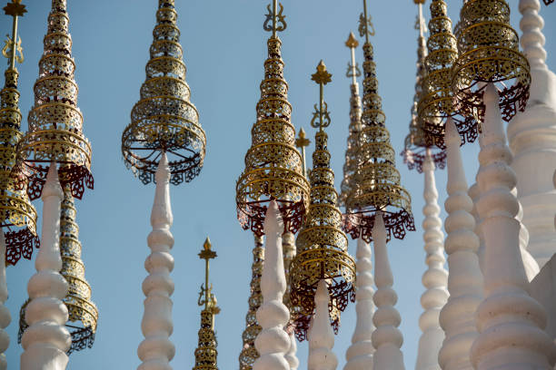 the white and golden Stupas and chedi at a rood of a temple at Wat Pong Sunan Temple in the city of  Phrae in the north of Thailand.  Thailand, Phrae November, 2018.