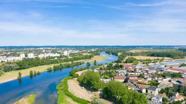 This photo was taken in France, in Burgundy, in Nevers in summer. We see the Loire flowing between the districts of the city of Nevers.