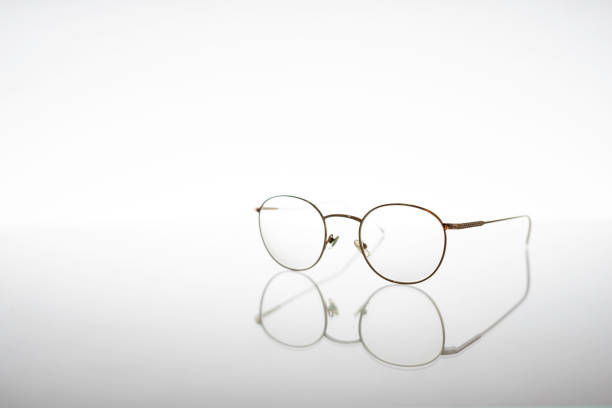 istock Golden metallic eyeglasses for vision issues or protection, isolated on white background with reflex and with copy space 1164013771
