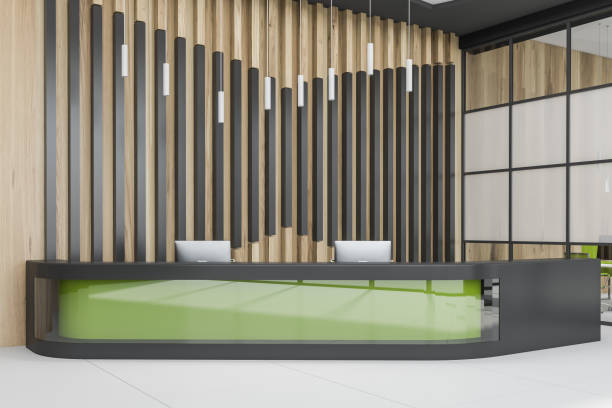 istock Green reception desk in wooden office interior 1164013916