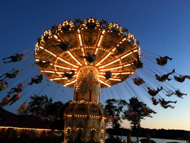 istock illuminated swing ride at dusk at an amusement park 1164015122