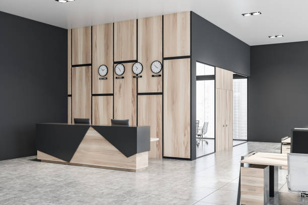 istock Wooden reception desk in office with clocks 1164015880