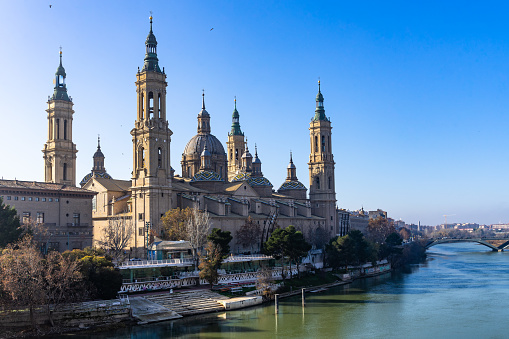 Cathedral of Our Lady of the Pillar (Nuestra Señora del Pilar) seen from Puente de Piedra bridge on the Ebro river. Zaragoza, Aragon, Spain, December 2018