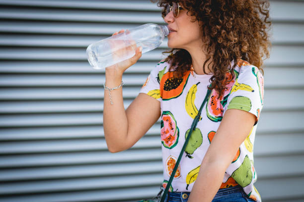 istock hydration during the summer. a young woman drinks water 1164017456