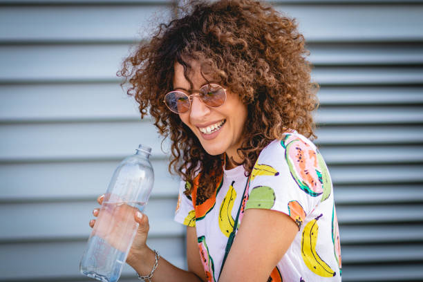 istock hydration during the summer. a young woman drinks water 1164017457