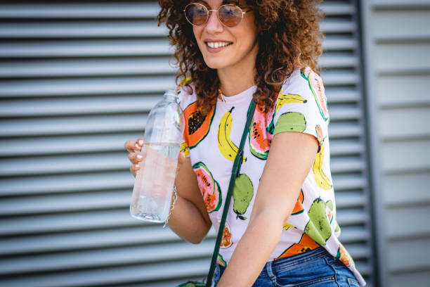 istock hydration during the summer. a young woman drinks water 1164017509