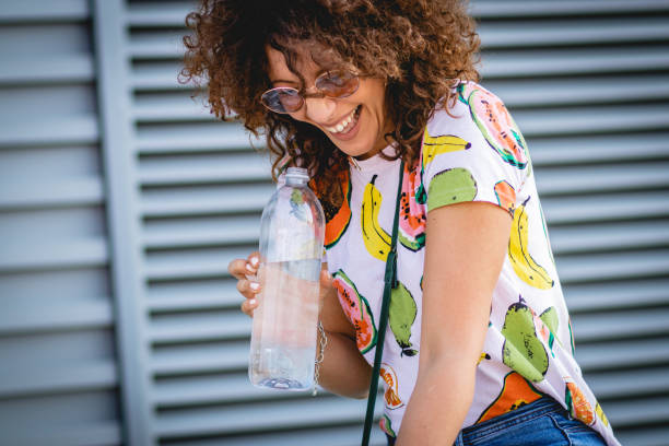 istock hydration during the summer. a young woman drinks water 1164017511