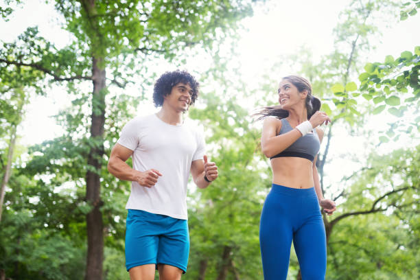 istock Happy young people jogging and exercising in nature 1164019122