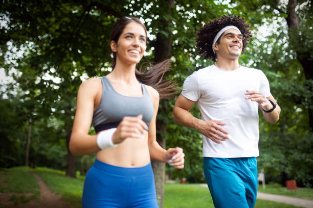 istock Happy young people jogging and exercising in nature 1164019140