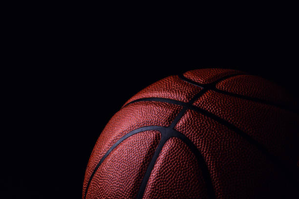 istock basketball ball on black background. 1164019303